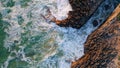 Top view rough waves making white foam. Ocean surf rolling on coastal cliffs Royalty Free Stock Photo