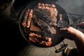 Top view on grill with pieces of fried meat and fish in center