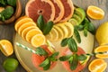 Top view round tray with sliced juicy citrus, two cocktails on table Royalty Free Stock Photo