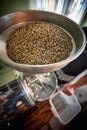 top view of rounded metal dish with whole grin coffee in it