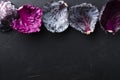Top view of row of red cabbage leaves on the dark surface.Empty space Royalty Free Stock Photo