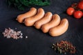 top view row of short thick sausages with dill and tomatoes Royalty Free Stock Photo