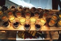 Top view rows of glasses with sweet vanilla pudding or fruit dessert on wooden self. Celebration, party, birthday or