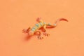 Top view of the rubber lizard toy isolated on an orange background Royalty Free Stock Photo