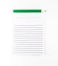 Top view of Ruled paper notepad with green pencil on white background Leave space for adding your content Royalty Free Stock Photo