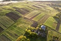 Top view of rural landscape on sunny spring day. Farm cottage, houses and barns on green and black fields. Drone photography Royalty Free Stock Photo