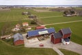 Top view of rural landscape on sunny spring day. Farm with solar photo voltaic panels system on wooden building, barn or house Royalty Free Stock Photo