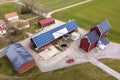 Top view of rural landscape on sunny spring day. Farm with solar photo voltaic panels system on wooden building, barn or house Royalty Free Stock Photo