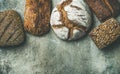 Top view of rustic bread loaves over grey background Royalty Free Stock Photo