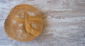 Top view on rustic home bread on a wooden background