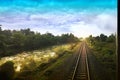 Top view of the rusty rails crossing the green field in a summer day , Northern Railway Thailand Royalty Free Stock Photo