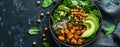 Top view of a salad with avocado, quinoa, sweet potato, spinach, chickpeas in a black bowl Royalty Free Stock Photo