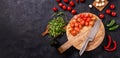 Top view of salad ingredients with mozzarella cheese, tomatoes and herbs on a wooden chopping board, flat lay Royalty Free Stock Photo