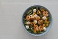 Top view of salad with mango, mozzarella, shrimps and mixed microgreens in blue bowl on white oak table Royalty Free Stock Photo