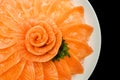 Top view of salmon sashimi serve on flower shape in white ice bowl boat isolated on black background, Japanese style Royalty Free Stock Photo