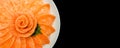 Top view of salmon sashimi serve on flower shape in white ice bowl boat isolated on black background, Japanese style Royalty Free Stock Photo