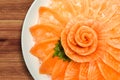 Top view of salmon sashimi serve on flower shape in white ice bowl boat on wood table background, Japanese style