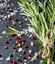 Top view salt and pepper on dark stone with rosemary