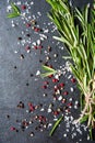 Top view salt and pepper on dark stone with rosemary