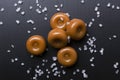 Top view of salted caramel candies, salt on the dark table Royalty Free Stock Photo