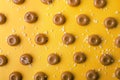 Top view of salted caramel candies on the yellow surface, closeup Royalty Free Stock Photo