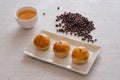 Top view of Salted Egg Yolk Pastry slices on white plate, adzuki beans and oolong tea cup on a table Royalty Free Stock Photo