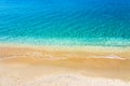 Top view of sandy beach and turquoise ocean water with small waves, beautiful summer sea background