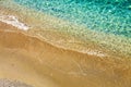 Top view of sandy beach and turquoise ocean water with small waves, beautiful summer sea background Royalty Free Stock Photo