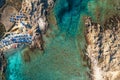 Top view of sandy beach with turquoise sea water and colorful blue umbrellas on the Sunset, Islands of Sardinia in Italy Royalty Free Stock Photo
