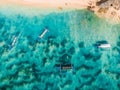 Top view of sandy beach with turquoise sea water and local boats, aerial shot Royalty Free Stock Photo