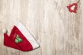 Top view of a Santa Claus hat and a red little wooden Christmas tree on the top left corner Royalty Free Stock Photo