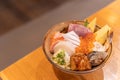 Top view of Sashimi Don, Donburi or Japanese rice bowl with various raw fresh slice of fish, shrimp, squid and tamago egg Royalty Free Stock Photo