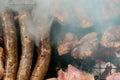 Top view of sausage and meat grilling on barbecue Royalty Free Stock Photo
