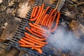 Top view of sausages barbequing on an old rusty brazier