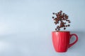 Top view of scattering coffee beans from a cup isolated on a gray background