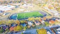 Top view school football field with running track, soccer goal, artificial playing surface and colorful autumn leaves near Dallas Royalty Free Stock Photo