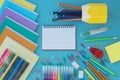 Top view of school supplies lie on blue background, top view. Royalty Free Stock Photo