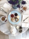 Top view of scones with milk and hot tea,tea break time with dessert on marble table Royalty Free Stock Photo