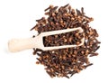 Top view of scoop on pile of dried cloves on white Royalty Free Stock Photo
