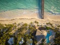 Top view of the sea beach. Fanciful roofs of small houses, a white sandy beach, a swimming pool, a bridge in the warm turquoise Royalty Free Stock Photo