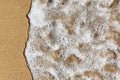 Top view of sea foam and beach sand. Sea wave. Close up