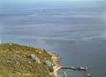 Top view of the sea, houses, trees and pier. Aerial photography of the landscape from above