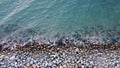 Top view of sea stones along the shore or granite pebbles. Background of wet stone by the sea. Royalty Free Stock Photo