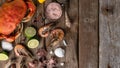 Top view of seafood banner with crab, shrimps, octopuses, lime, lemon, seashells and sea salts on rustic wooden background. Tasty