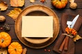 Top view of seasonal table setting with pumpkins and autumn leaves on wooden background. Thanksgiving Day Royalty Free Stock Photo