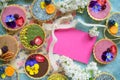 Top view of selection of colorful and delicious cake desserts in box on table. Copy space.