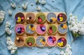 Top view of selection of colorful and delicious cake desserts in box on table.