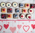 Top view of selection of colorful and delicious cake desserts on table.