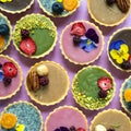 Top view of selection of colorful and delicious cake desserts on table.