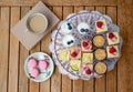 Top view of selection of colorful and delicious cake desserts on tray on table.